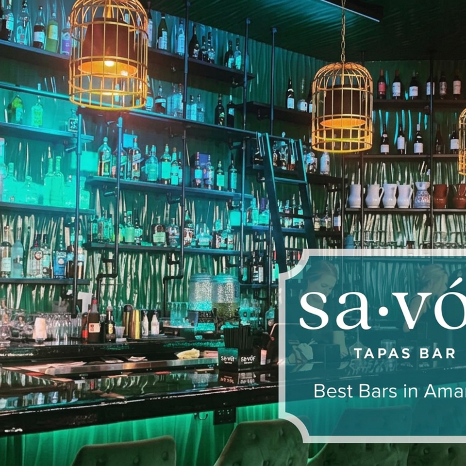 Vibrant Savór Tapas Bar interior with liquor-filled shelves, birdcage pendant lights, glowing bar, and green velvet seating.